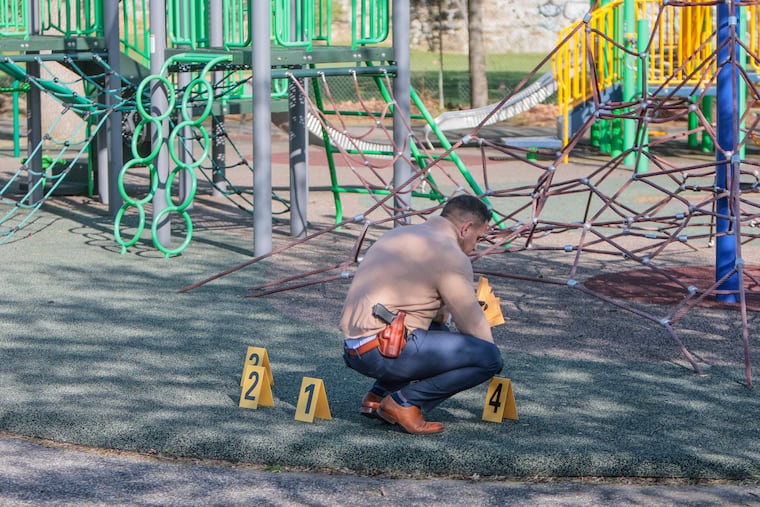 A detective works the crime scene at the Marie Dendy Recreation Center at 10th and Jefferson Streets, where a 15-year-old boy was shot in the back on April 19, 2023.