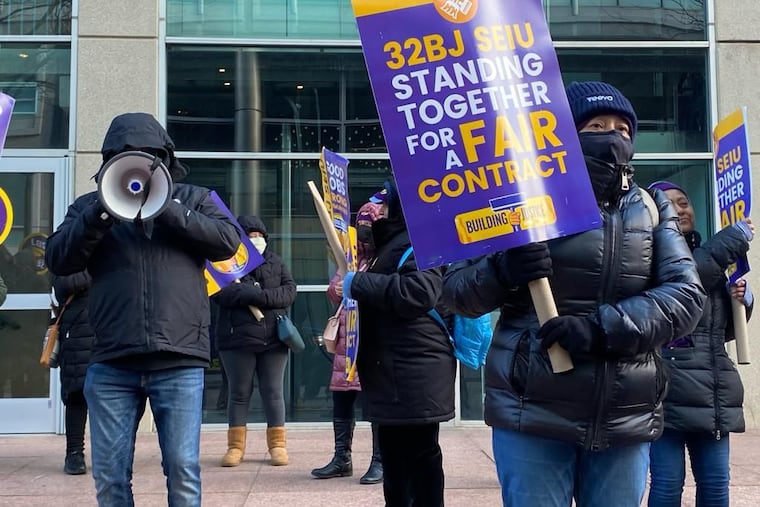 Commercial office cleaners who are members of Service Employees International Union (SEIU) Local 32BJ march in Conshohocken on Tuesday, Nov. 28, demanding a better contract.