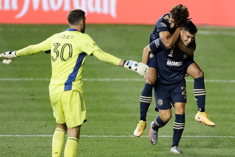 Union midfielder Anthony Fontana, right, gets congratulated by Matt Real after scoring the first of his two goals in the second half.