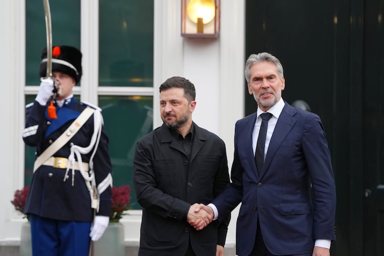 Dutch Prime Minister Dick Schoof, right, welcomes Ukraine's President Volodymyr Zelenskyy in The Hague, Netherlands, Tuesday, Dec. 16, 2025. (AP Photo/Peter Dejong)