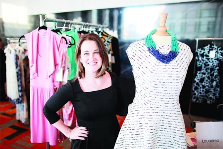 Rachel Godwin Becker, owner/designer of the Aston dress line Laundrea, with her frocks. At $150 to $198, they're selling out at local boutiques. (David Swanson/Staff Photographer)