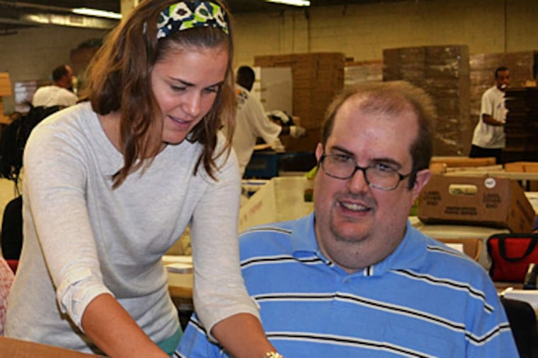 Jackie Michel (left) was one of the Jefferson University students who provided occupational therapy for Baker Industries workers.