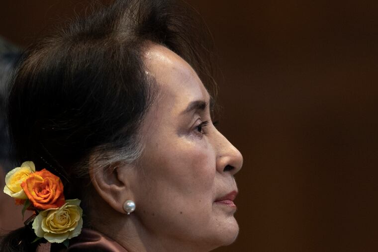 Myanmar's leader Aung San Suu Kyi takes her seat when entering the court room of the International Court of Justice for the first day of three days of hearings in The Hague, Netherlands, Tuesday, Dec. 10, 2019.