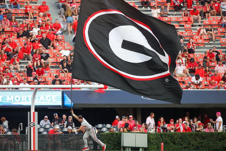 A Georgia cheerleader runs a flag across the end zone after a touchdown in the second half of an NCAA college football game against Vanderbilt, Saturday, Oct. 15, 2022, in Athens, Ga.