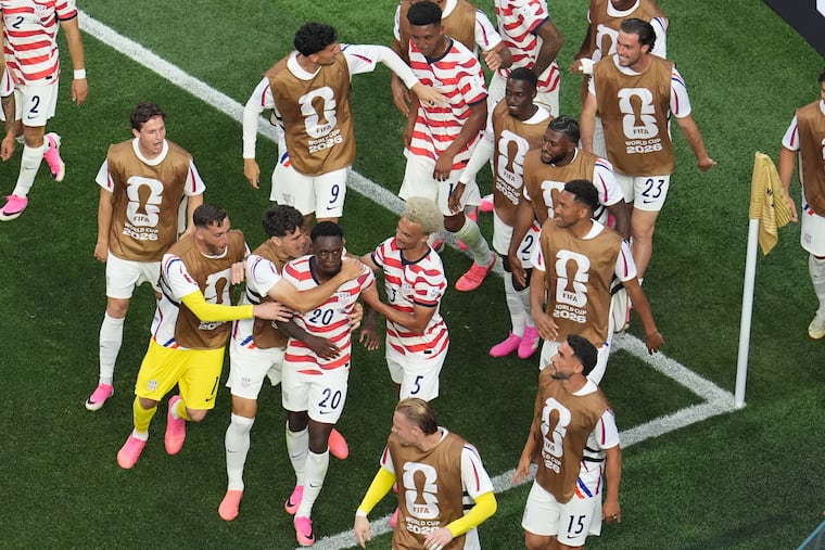 Folarin Balogun (center) celebrates with teammates after scoring one of his two goals for the U.S. against Paraguay.