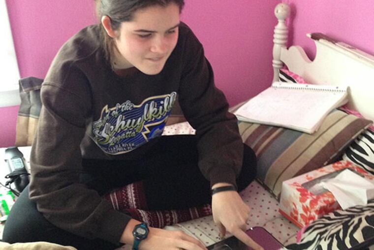 Colette McDonald,16 and junior at Archbishop Bonner-Prendie works on her computer at home. (Denise McDonald photo)