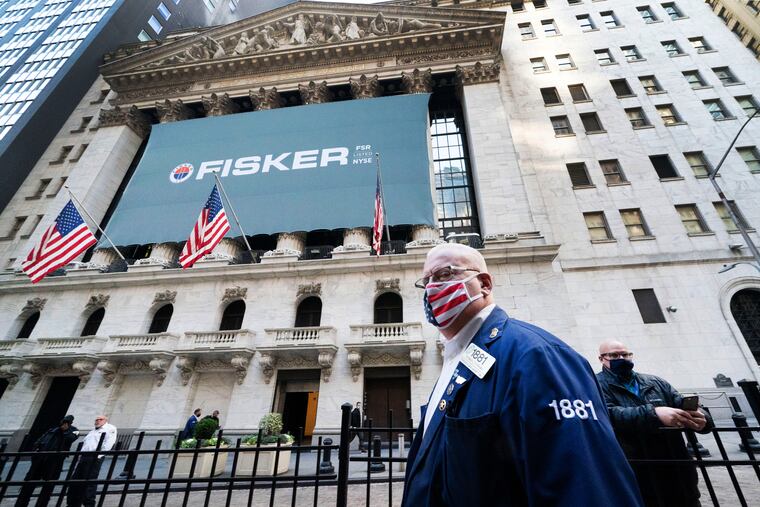 Stock trader Thomas Ferrigno arrives to work at the New York Stock Exchange, Monday, Nov. 9, 2020. World markets rocketed higher after Pfizer said early data show its coronavirus vaccine is effective.