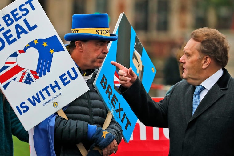 Protestors react as they demonstrate in front of the Houses of Parliament in London, Wednesday, March 6, 2019. Britain's chief law officer said Wednesday that Brexit negotiations with the European Union had got to "the meat of the matter," after Northern Ireland's top civil servant warned that a disorderly U.K. exit could destabilize both the economy and the peace process.