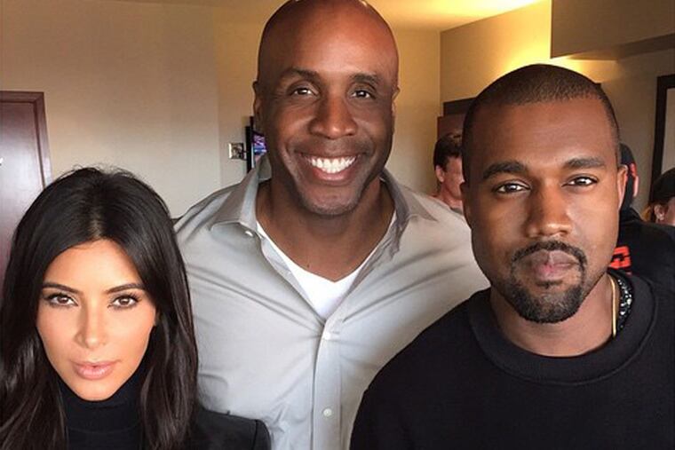 Kim Kardashian, Barry Bonds and Kanye West at San Francisco’s AT&T Park to watch the Giants-Royals World Series game, and to mark the one-year anniversary of the couple’s engagement.