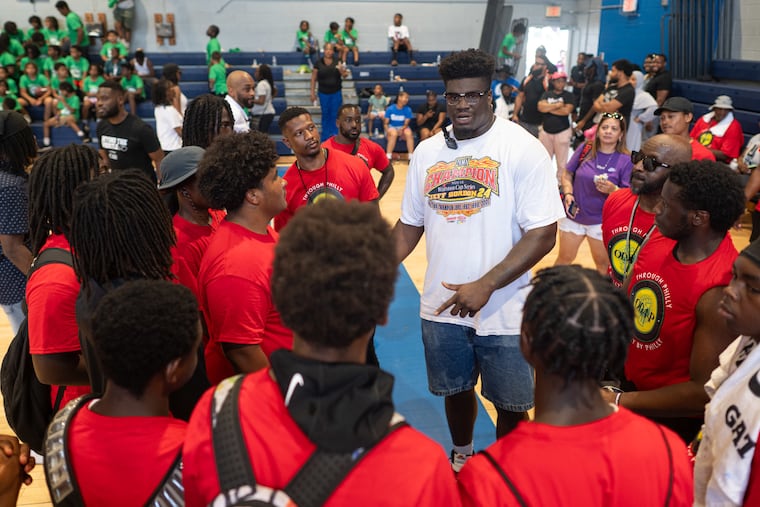 Jordan Davis speaks to volunteer coaches at a youth football clinic on Saturday at Mastery Charter School North.