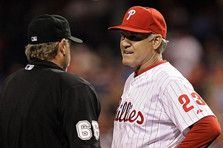 Phillies manager Ryne Sandberg confers with umpire Jim Joyce in the eighth inning. (Laurence Kesterson/AP)