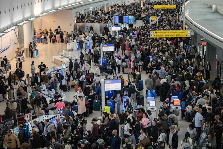 People wait in a TSA line at the John F. Kennedy International Airport, Sunday, March 22, 2026, in New York.