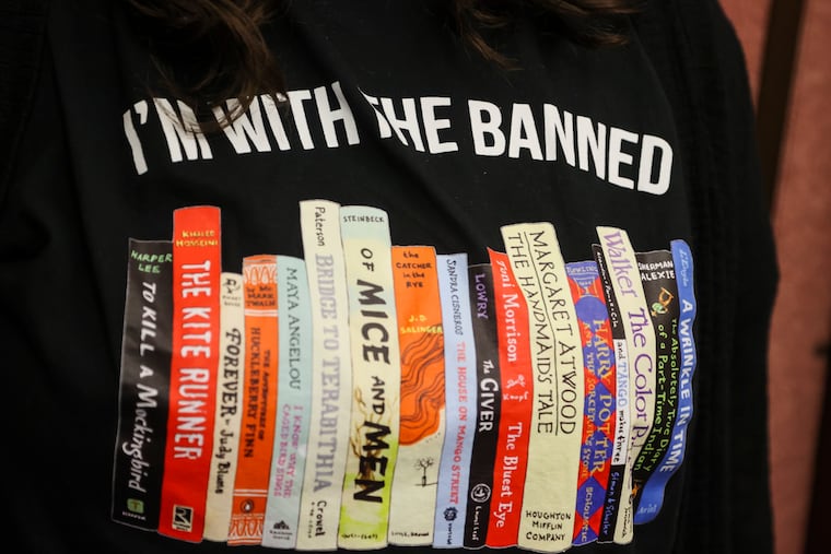 A Largo High School English teacher wears a shirt against banning books at the Pinellas County School Board meeting in Largo, Fla., Feb. 14, 2023.