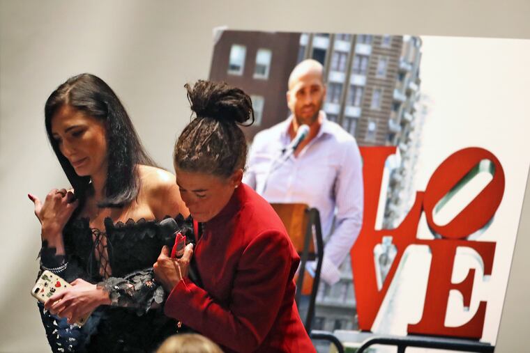 Mother Linda Schellenger helps fiancee Iryna Iryk off stage at a memorial featuring friends and family at a service for Sean Schellenger, killed in a stabbing near Rittenhouse Square, at Radnor High School July 17, 2017.