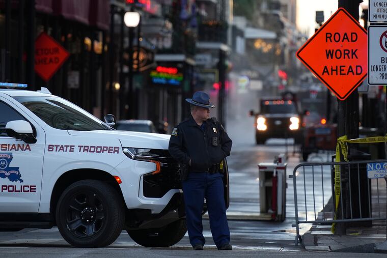 A state trooper stands by New Orleans' Canal and Bourbon Streets on Thursday.