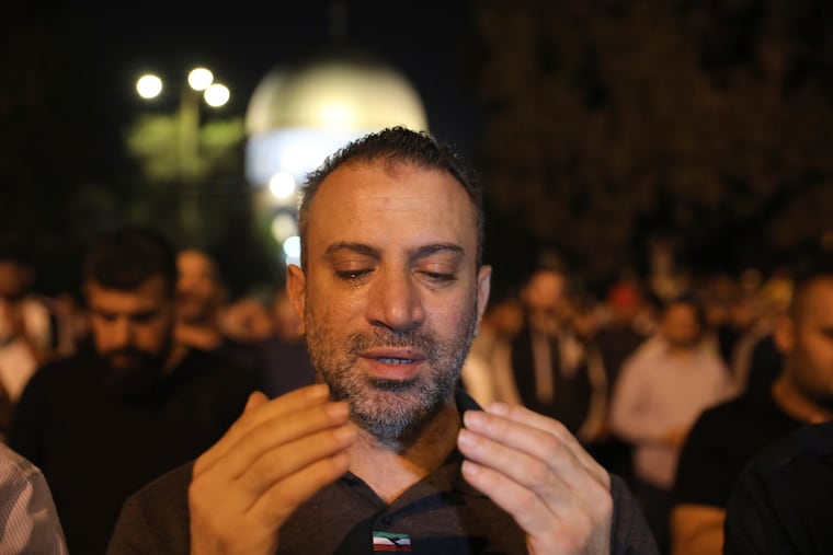 A worshipper prays during the Laylat al-Qadr, or the night of destiny, in the holy fasting month of Ramadan, in the Al Aqsa Mosque compound in Jerusalem's Old City Saturday, May 8, 2021.