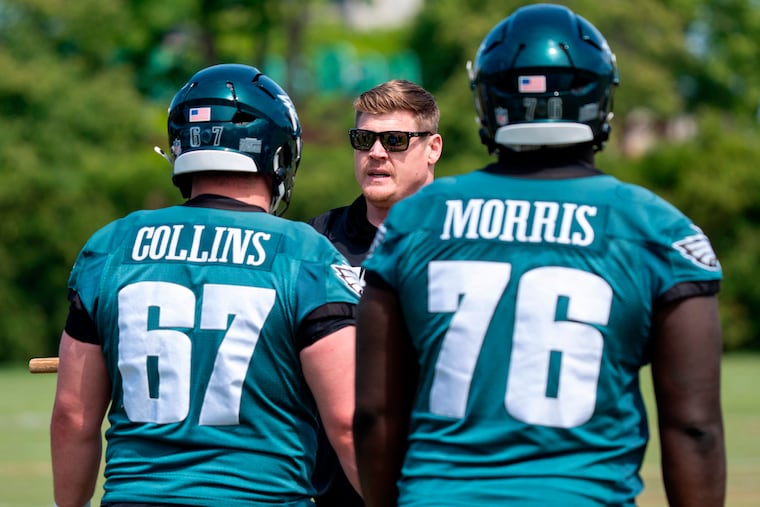 Chris Kuper (center) is replacing franchise staple Jeff Stoutland as offensive line coach in 2026.