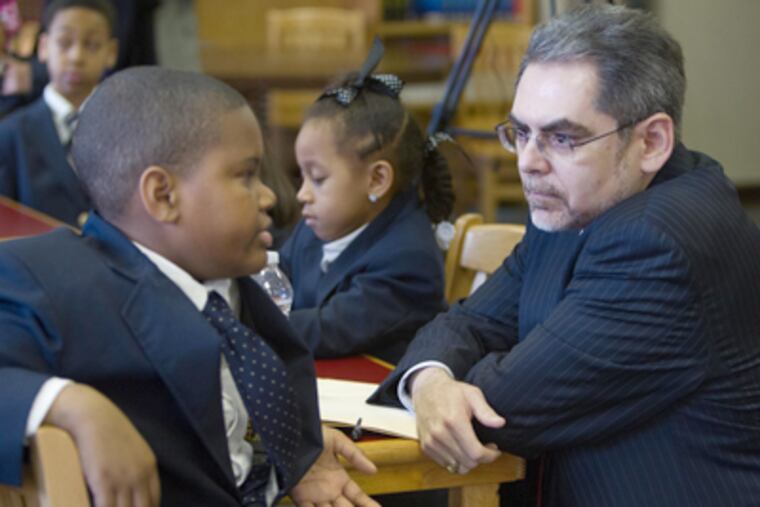 SRC Chairman Pedro Ramos with Dunbar Elementary sixth grader Samuel Smith IV. SRC members and Nutter will visit Denver to eye its schools. (David M Warren / Staff Photographer)