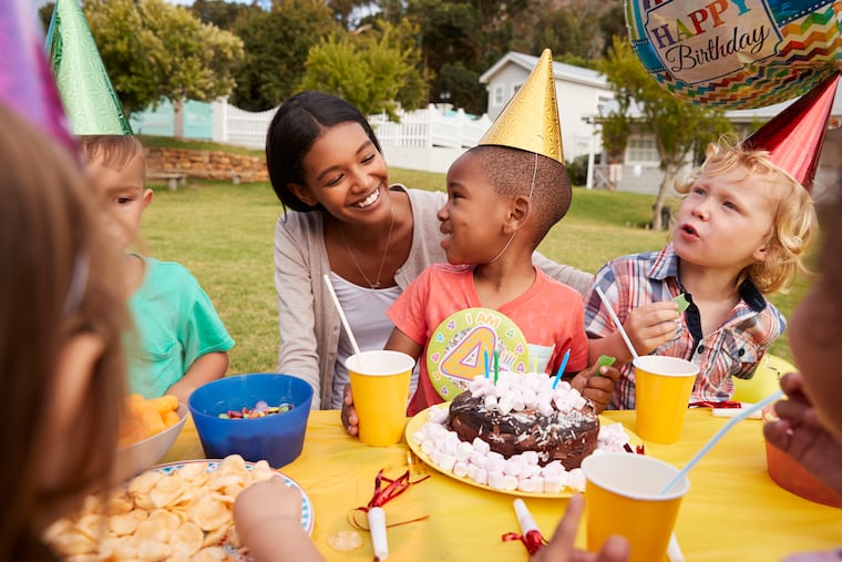 Mother With Children Enjoying Outdoor Birthday Party Together