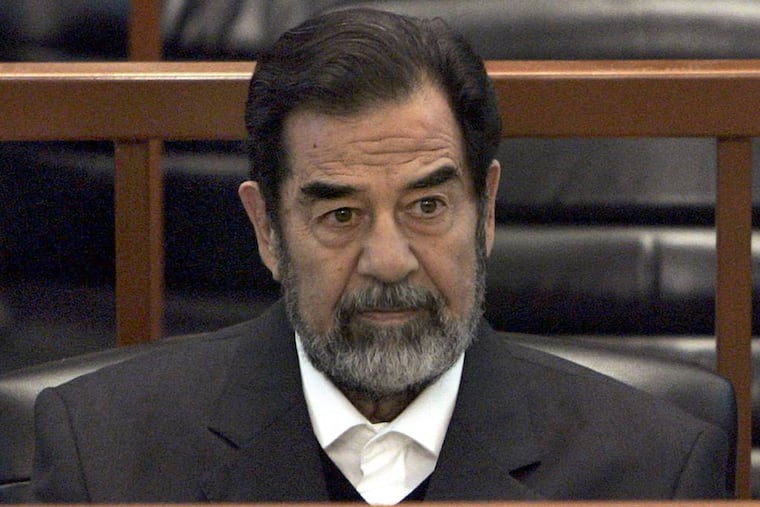 FILE - In this Dec. 6, 2006 file photo, former Iraq leader Saddam Hussein sits in court in Baghdad, Iraq, during the "Anfal" trial against him. Republican Donald Trump is again praising the former Iraqi President Hussein's ruthlessness, saying he killed terrorists "so good." Trump was speaking at a rally Tuesday, July 5, 2016, in North Carolina when he turned to the former Iraqi leader.