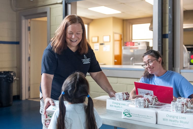 Dee D’Aulerio, Director at Holy Innocents OST, is handing out the premade meals for the kids at Holy Innocents Catholic Church in Philadelphia, Pa., on Tuesday, July 28, 2026.