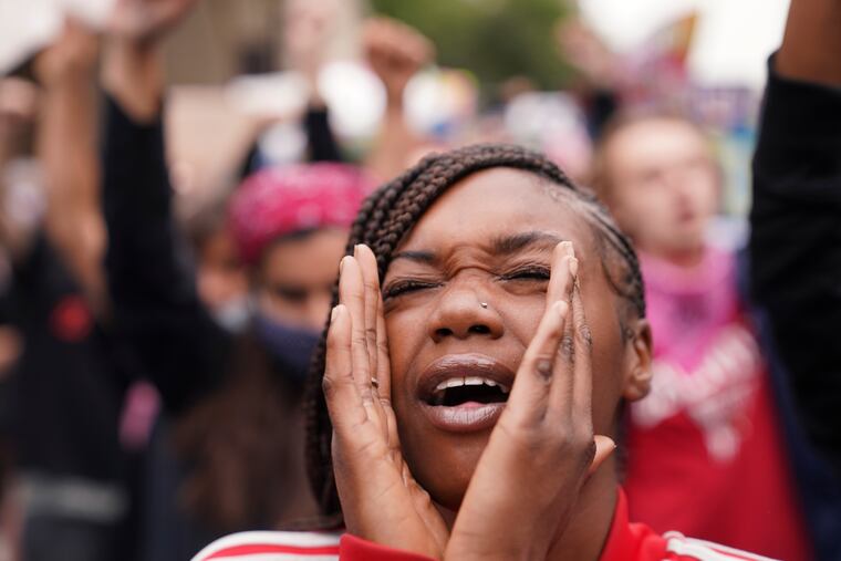A woman speaks during a protest on Wednesday in Louisville, Ky., after a grand jury indicted only one officer in connection with the Breonna Taylor case, but not for her killing.