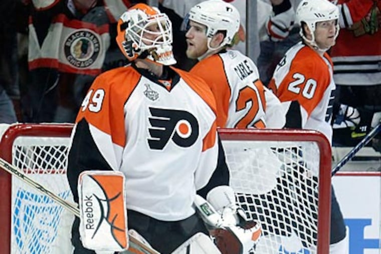 Michael Leighton struggled against a surging Blackhawks offense. (Yong Kim/Staff Photographer)