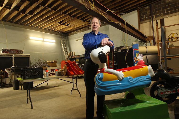 Jon Perper, owner of the Playdrome bowling alley, stands among old arcade games in the what used to be the swimming pool area of the Jim Corea Gym, and later the Bobby Clark Gym in Cherry Hill. ( Michael Bryant / Staff Photographer )