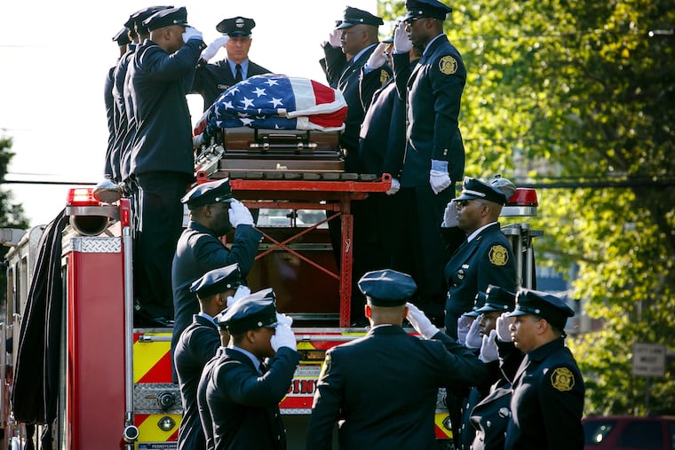 Firefighters salute during the funeral procession for Fire Lt. Benny Hutchins, in Philadelphia, Wednesday, July 11, 2018. Hutchins died after suffering a medical emergency during a training exercise at the Fire Academy in Holmesburg on Wednesday, June 27, 2018.