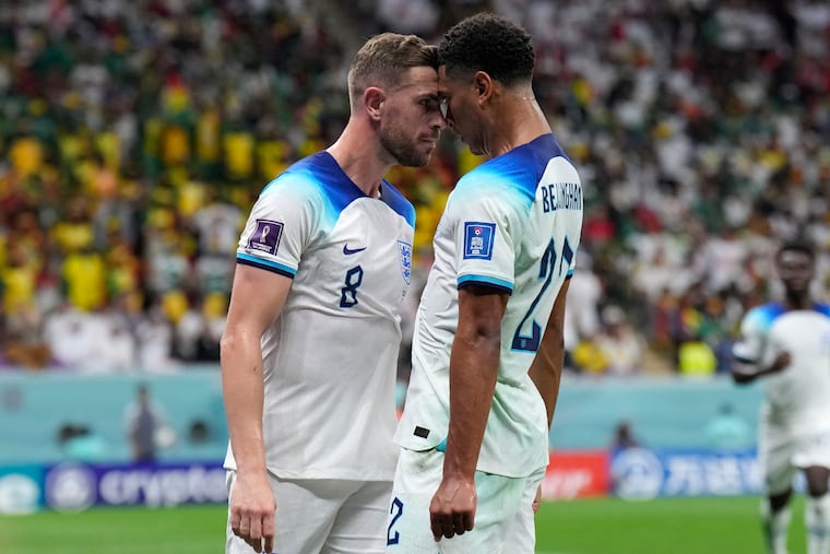 Jude Bellingham (right) and Jordan Henderson (left) celebrate after teaming up on Henderson's goal for England against Senegal.