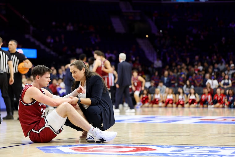 Penn Quakers forward Ethan Roberts (23) is tended to by an athletic trainer early in the second half against the Villanova Wildcats in the Big 5 Men’s Basketball Championship at Xfinity Mobile Arena on Saturday, Dec. 6, 2025, in Philadelphia.