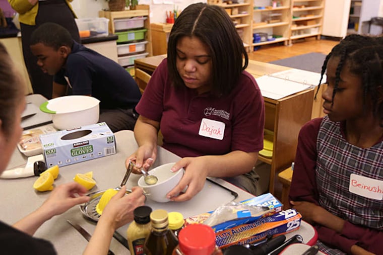 Dajah Bryant (left) and Beinushi Jean-Pierre measure mustard and lemon juice. (DAVID SWANSON / Staff Photographer)