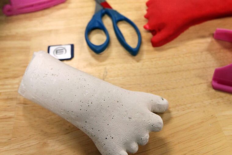 A casting of the hand of Shea Stollenwerk, 9, sits on a workbench at the University of Wisconsin - Milwaukee where students and designers are creating a prostethic hand for her. (Kristyna Wentz-Graff/Milwaukee Journal Sentinel/MCT)