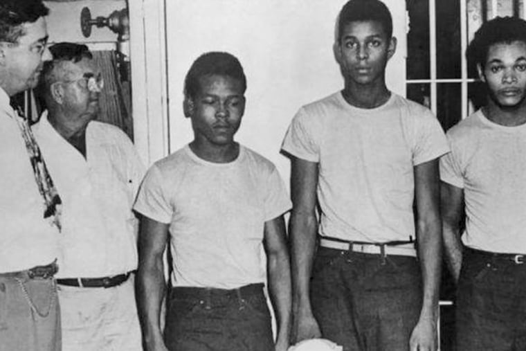 In this undated image released by the State Library and Archives of Florida, Lake County Sheriff Willis McCall, far left, and an unidentified man stand next to Walter Irvin, Samuel Shepherd and Charles Greenlee, from left, in Florida. The three men along with a fourth were charged with rape in 1949. Florida Gov. Ron DeSantis and a Cabinet granted posthumous pardons Friday, Jan. 11, 2019, to Shepherd, Irvin, Charles Greenlee and Ernest Thomas, the four African-American men accused of raping a white woman in 1949 in a case now seen as a racial injustice. (State Library and Archives of Florida via AP)