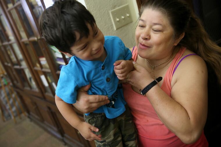 Suyapa Reyes, right, carries her son Jeison, then 2, up to their room in the First United Methodist Church of Germantown in Philadelphia on Sept. 4, 2018. The Reyes family began living in the church because they were at risk of being deported.