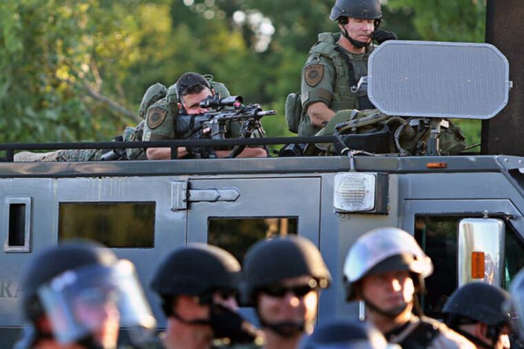Police in Ferguson, Mo., last summer. Sen. Pat Toomey says the president had insulted officers. (St. Louis Post-Dispatch)