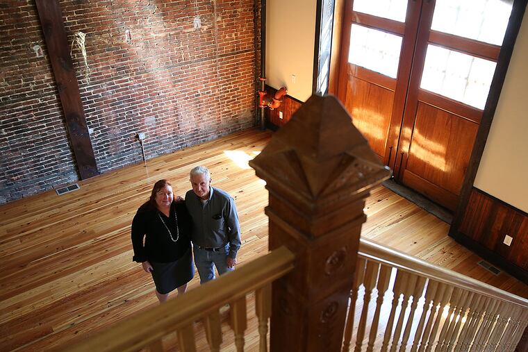 Lisa Kiernan, left, executive director of Heart of Camden, and Phil Nippins, right, director of construction for Heart of Camden, gather in the gallery.