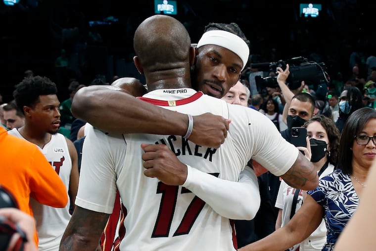 Jimmy Butler hugs teammate P.J. Tucker after the Heat defeated the Boston Celtics in Game 6 of the NBA's Eastern Conference finals.