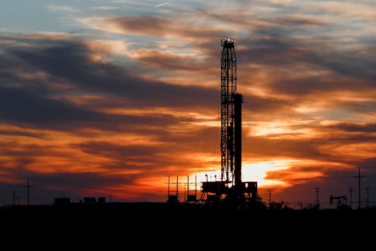 An oil rig stands against the setting sun in Midland, Texas.