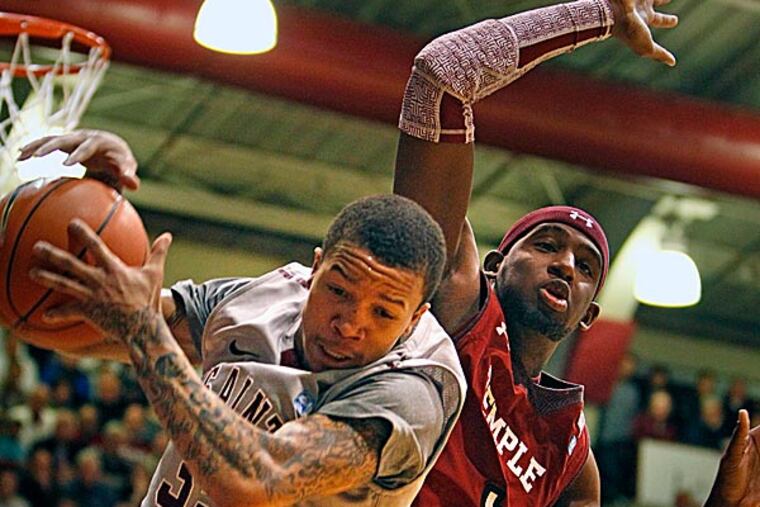 Saint Joseph's Carl Jones grabs a rebound next to Temple's Anthony Lee. (Ron Cortes/Staff Photographer)
