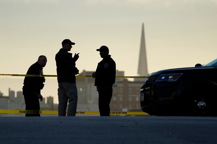 Police standing at the top of the closed street outside the home of House Speaker Nancy Pelosi and her husband, Paul Pelosi, in San Francisco on Friday. Hours earlier, Paul Pelosi was attacked and severely beaten by an assailant with a hammer.