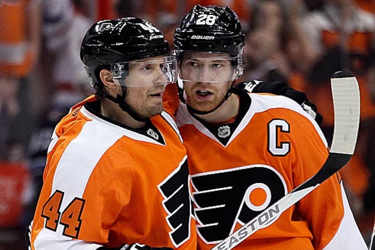 Claude Giroux (right) and Kimmo Timonen. (Tom Mihalek/AP)