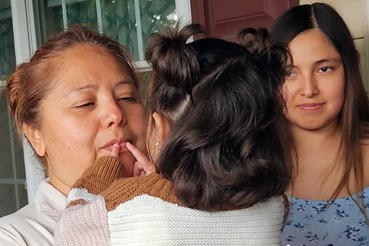 Maria Hernandez holds her granddaughter Selene, 1, during a Mother's Day vigil for her husband, Erasmo Zavala Almanza, held at their home in Temple, Berks County, on Sunday. The girl was critically wounded in the shooting that killed her mother. Erasmo Zavala Almanza was detained by ICE on April 15 and is facing deportation despite being a caregiver and financial provider for his granddaughter, whose parents died in a murder-suicide.