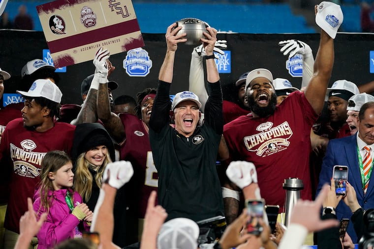 Florida State coach Mike Norvell lifts the trophy after the team's win over Louisville in the Atlantic Coast Conference championship. A 13-0 record was not good enough to gain a College Football Playoff berth.
