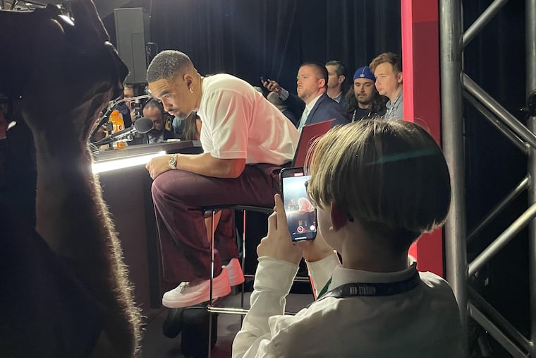 Eagles quarterback Jalen Hurts listens to a question from teen podcaster Giovanni Hamilton at a news conference at State Farm Stadium following Super Bowl LVII Sunday.