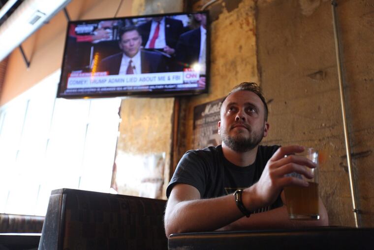 Joe Maiellano eats and drinks while watching James Comey testify.