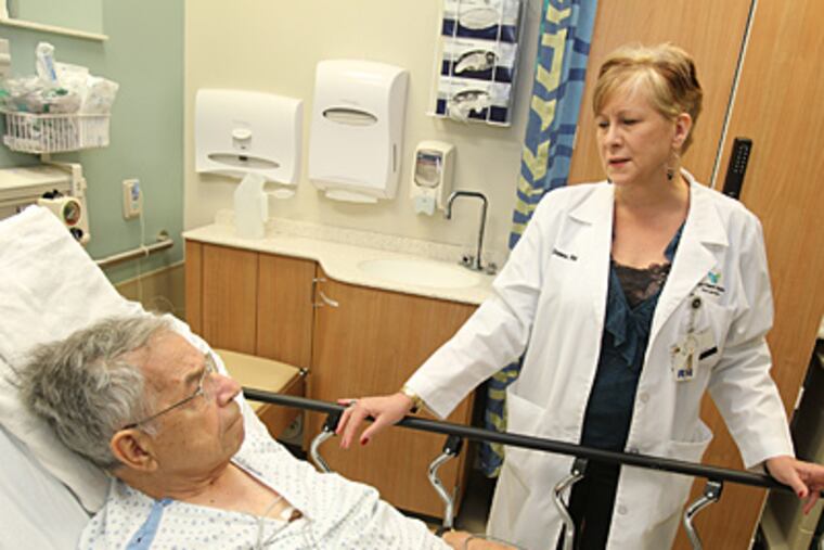 Meg Greene, a palliative-care nurse in the emergency department at Bryn Mawr Hospital, talks with Carmen Marchesani, who was admitted because of dizziness. (Charles Fox/Staff)
