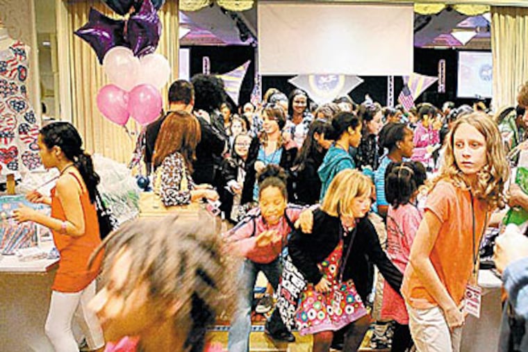 Attendees charge into the hall at the First National Tween Girl Summit at the Capital Hilton in Washington. (Robert Giroux / For the Inquirer)