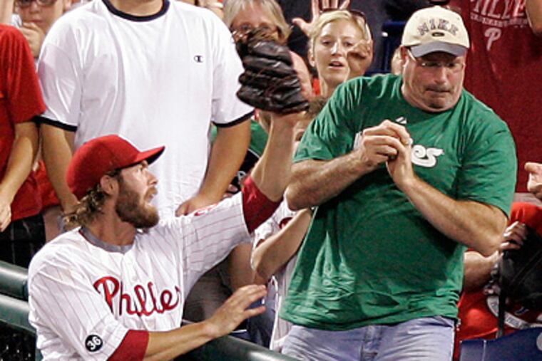 Jayson Werth and a Phillies fan have trouble over a foul ball during Thursday night's game. (David Swanson / Staff Photographer)