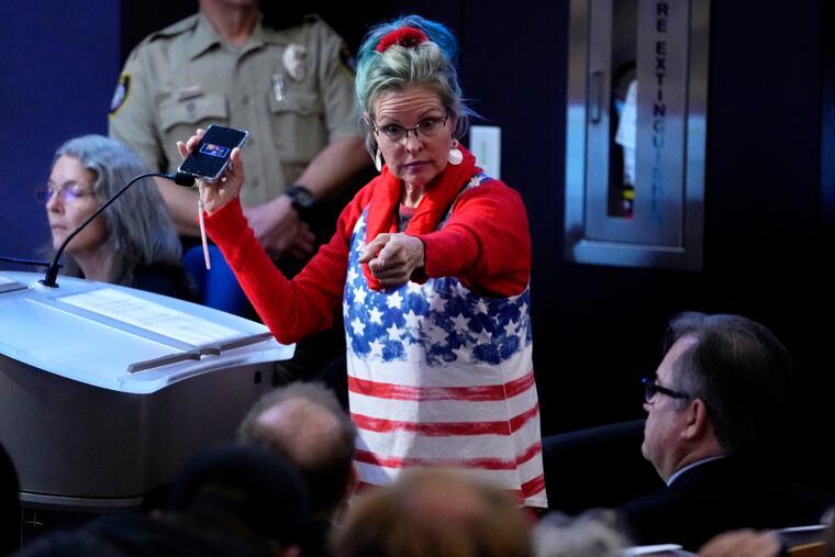 A woman points at Maricopa County Recorder Stephen Richer during the Maricopa County Board of Supervisors general election canvass meeting.